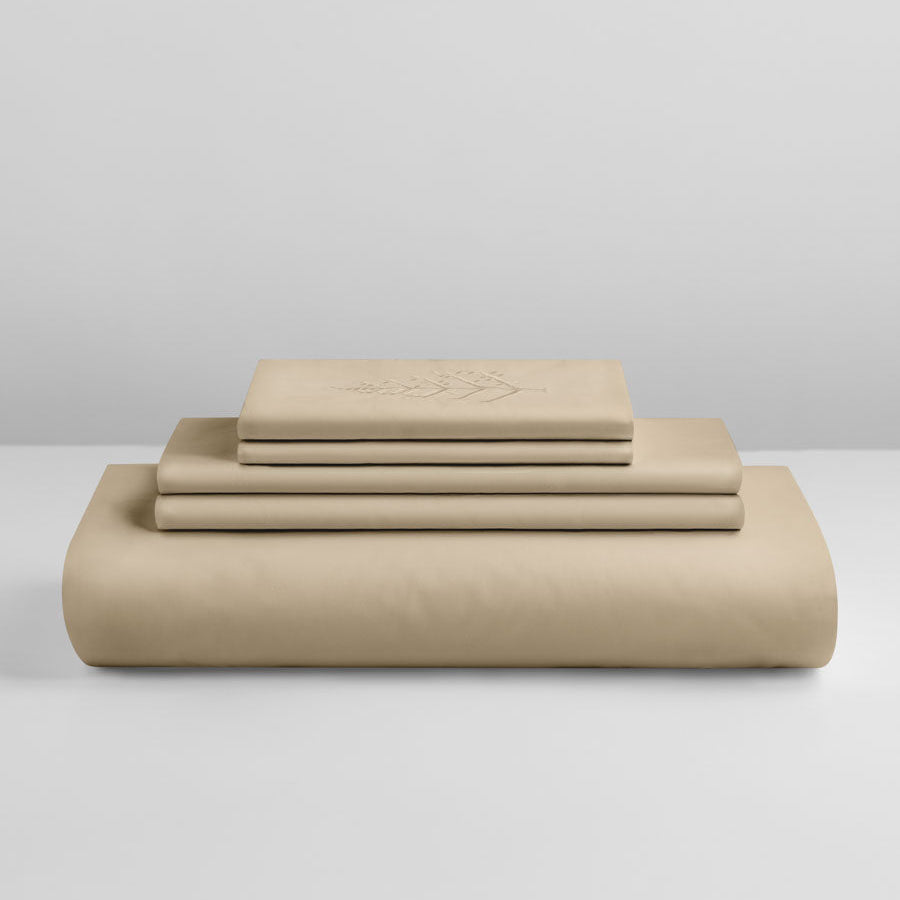 Egyptian Camel duvet cover set stacked: folded duvet and shams; top piece with tone-on-tone logo store embroidery. {{Egyptian Camel}}