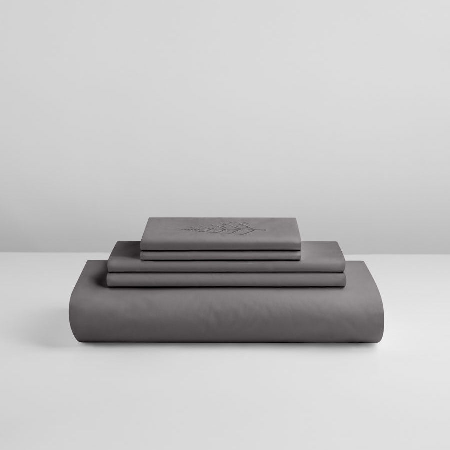 Hampshire Charcoal duvet cover set stacked: folded duvet and shams; top piece with tone-on-tone logo store embroidery {{Hampshire Charcoal}}