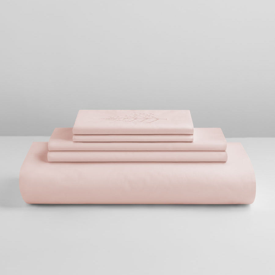 Kyoto Blush duvet cover set stacked: folded duvet and shams; top piece with tone-on-tone logo store embroidery. {{Kyoto Blush}}