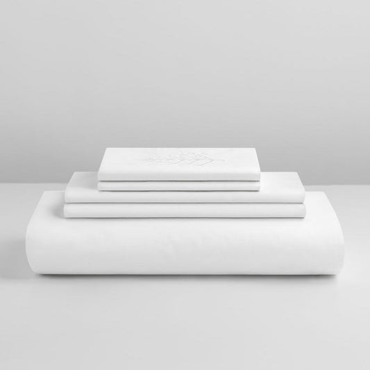 Signature White duvet cover set stacked: folded duvet and shams, tone-on-tone embroidered logo on top piece.{{Signature White}}