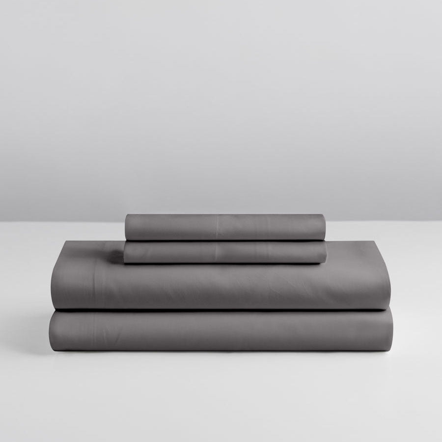 Stacked sheet set in Hampshire Charcoal showing fitted sheet, flat sheet, and two pillowcases. {{Hampshire Charcoal}}