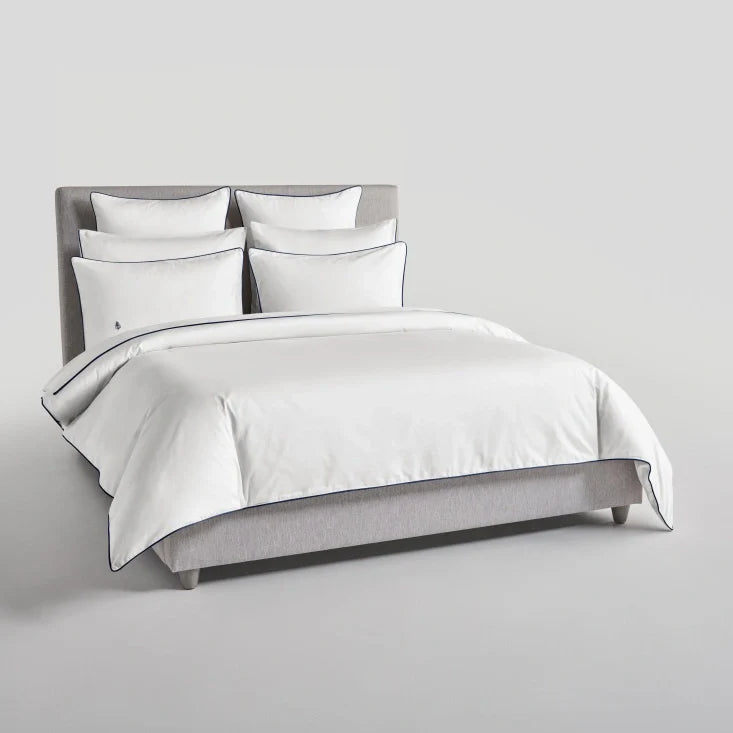 Bed with Signature White Sycamore duvet and pillows {{Signature White}}.