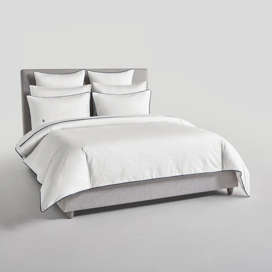 Bed with Signature White Sycamore duvet and pillows {{Signature White}}.