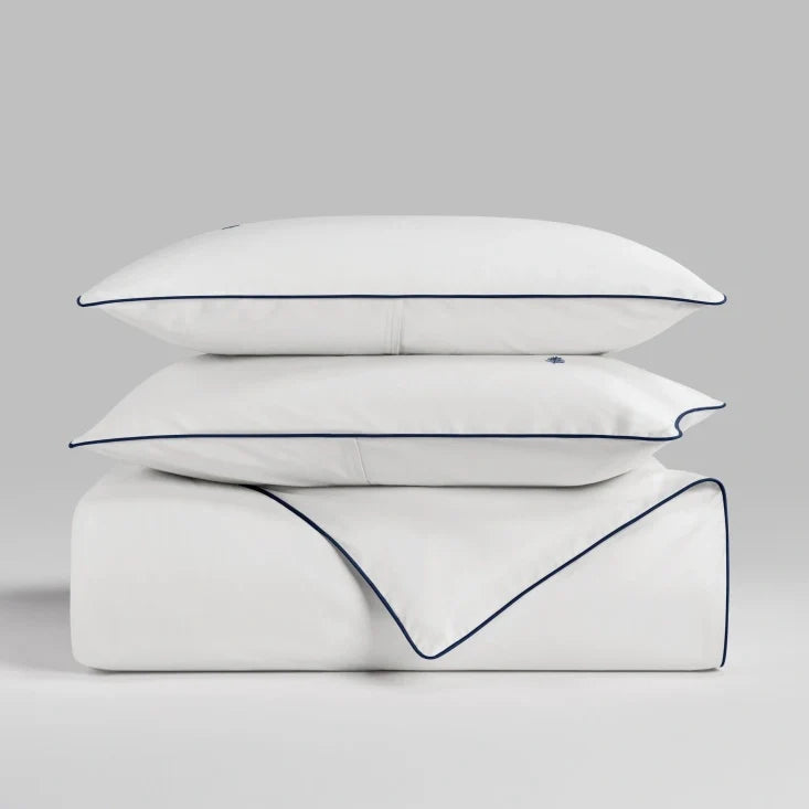 Sycamore Signature White duvet cover set stacked folded duvet and pillowcases. {{Signature White}}