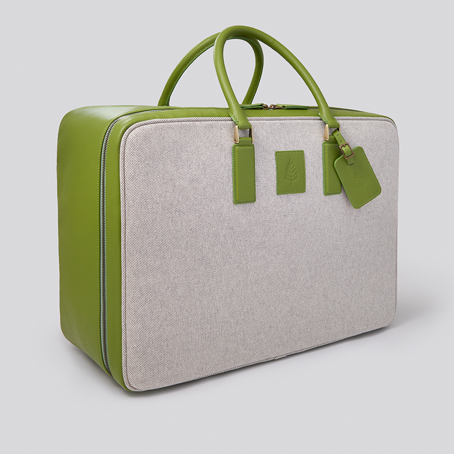 The Valisette travel bag in a vibrant Kyoto Matcha green, crafted from Italian Pebble Grain Leather and Organic Cotton Toile, is a stylish and sophisticated travel companion. - {{Kyoto Matcha}}