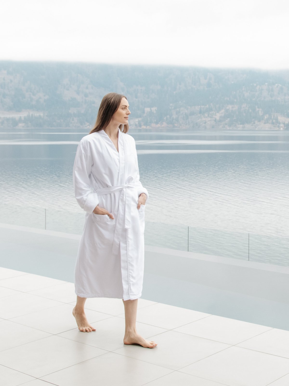 A woman walking outdoors wearing a comfortable spa robe.