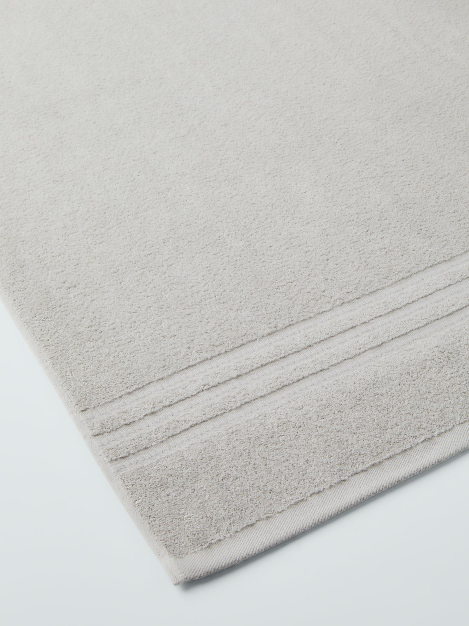 plush, folded bath sheets in a warm, inviting "Turkish Silver" color. The towels have a thick, textured weave and subtle stripes