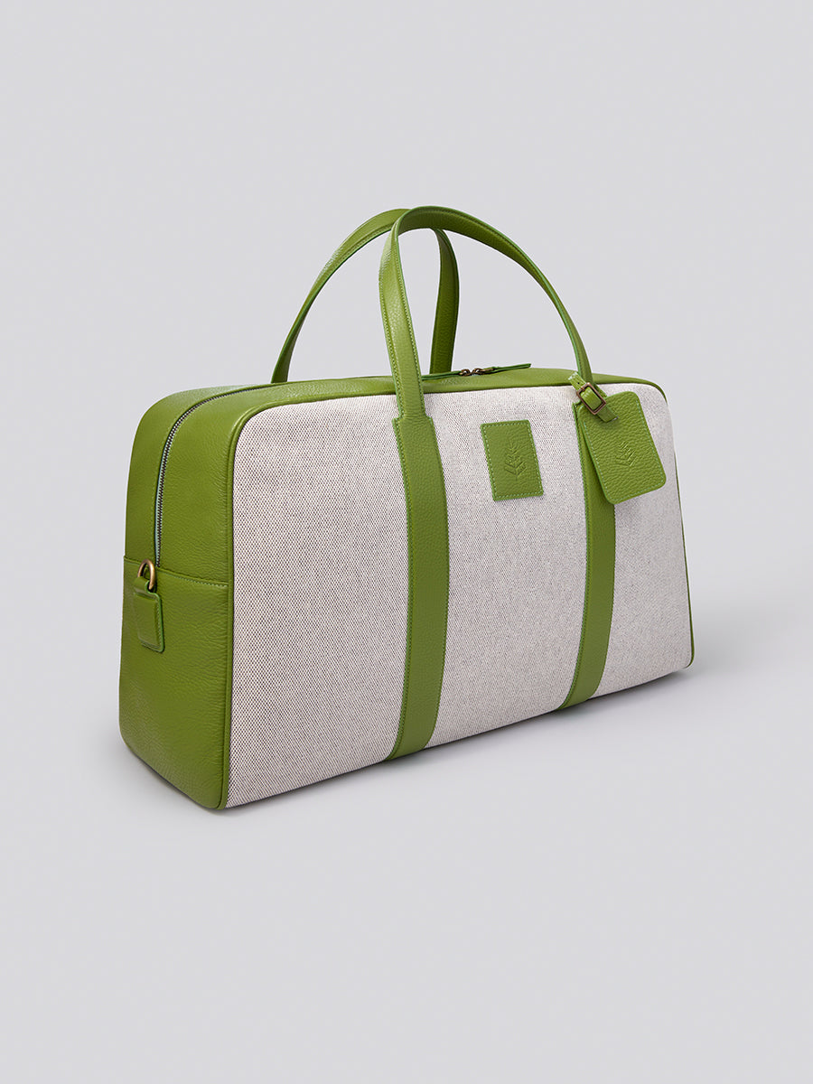 The Bowler travel bag, a versatile and stylish carry-on with a sleek design, crafted from Italian Pebble Grain Leather and Organic Cotton Toile.