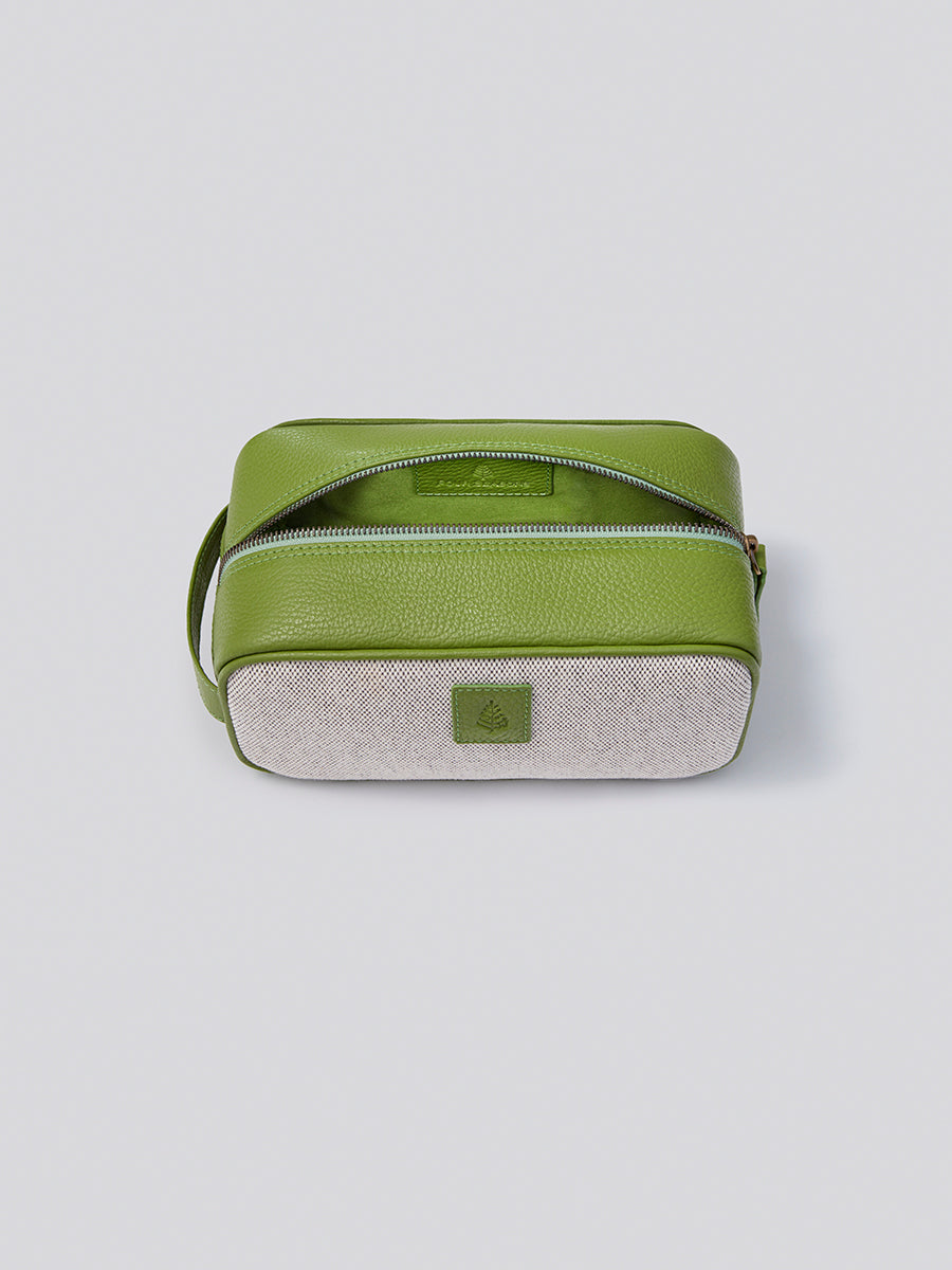 Top view of The Toiletries bag in Kyoto Matcha from the Four Seasons Travel Collection with the lid open."