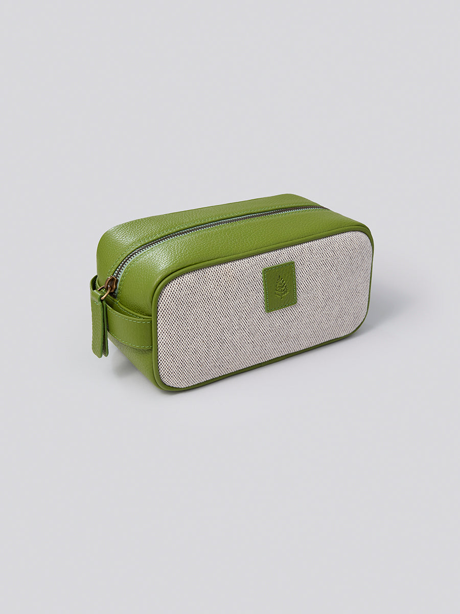 The Toiletries bag, a stylish and functional travel companion for organizing your grooming essentials, crafted from Italian Pebble Grain Leather and Organic Cotton Toile in a vibrant Kyoto Matcha green.