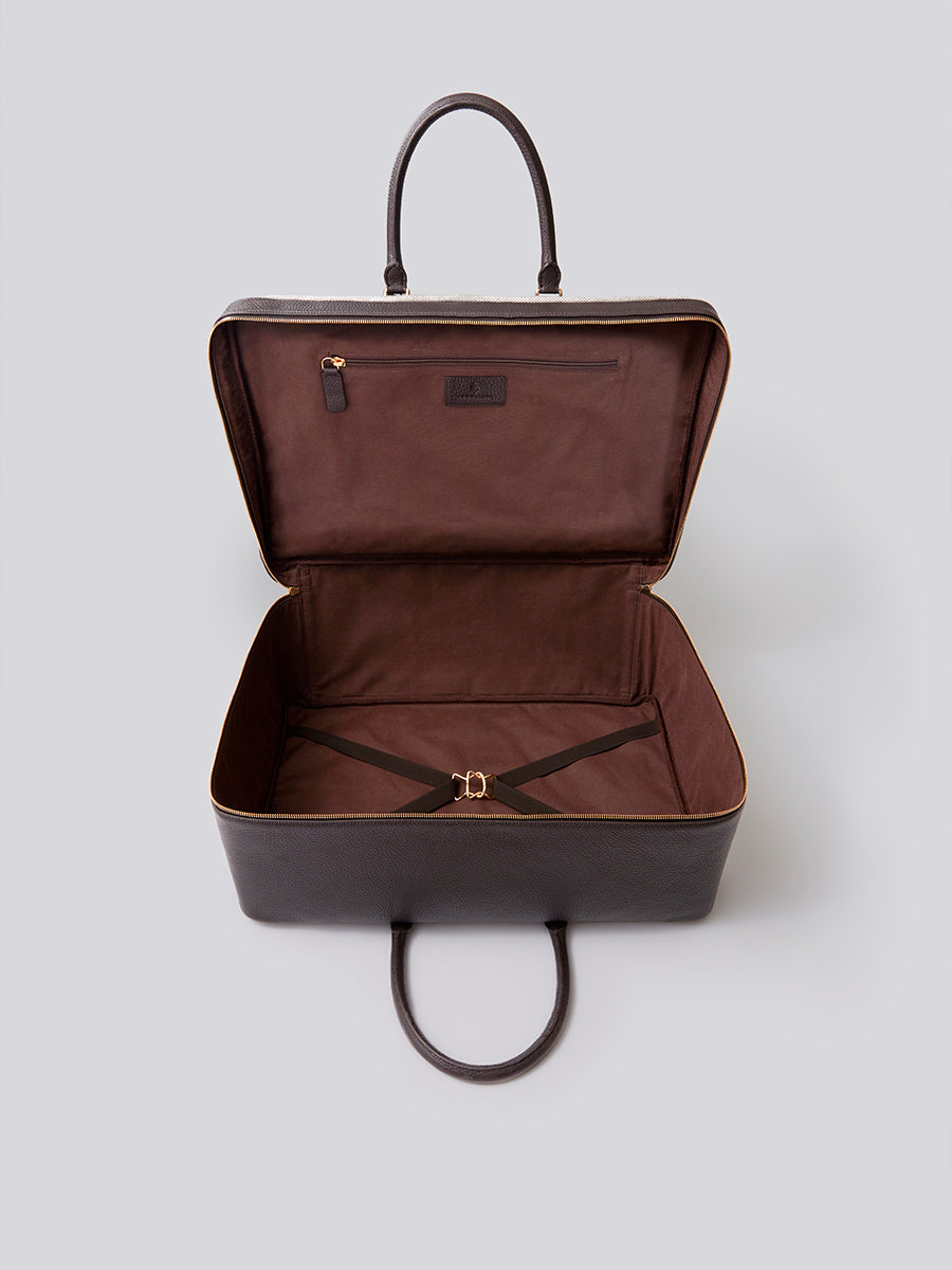 The Valisette travel bag in Malaysian Cocoa from the Four Seasons Travel Collection with the interior visible.